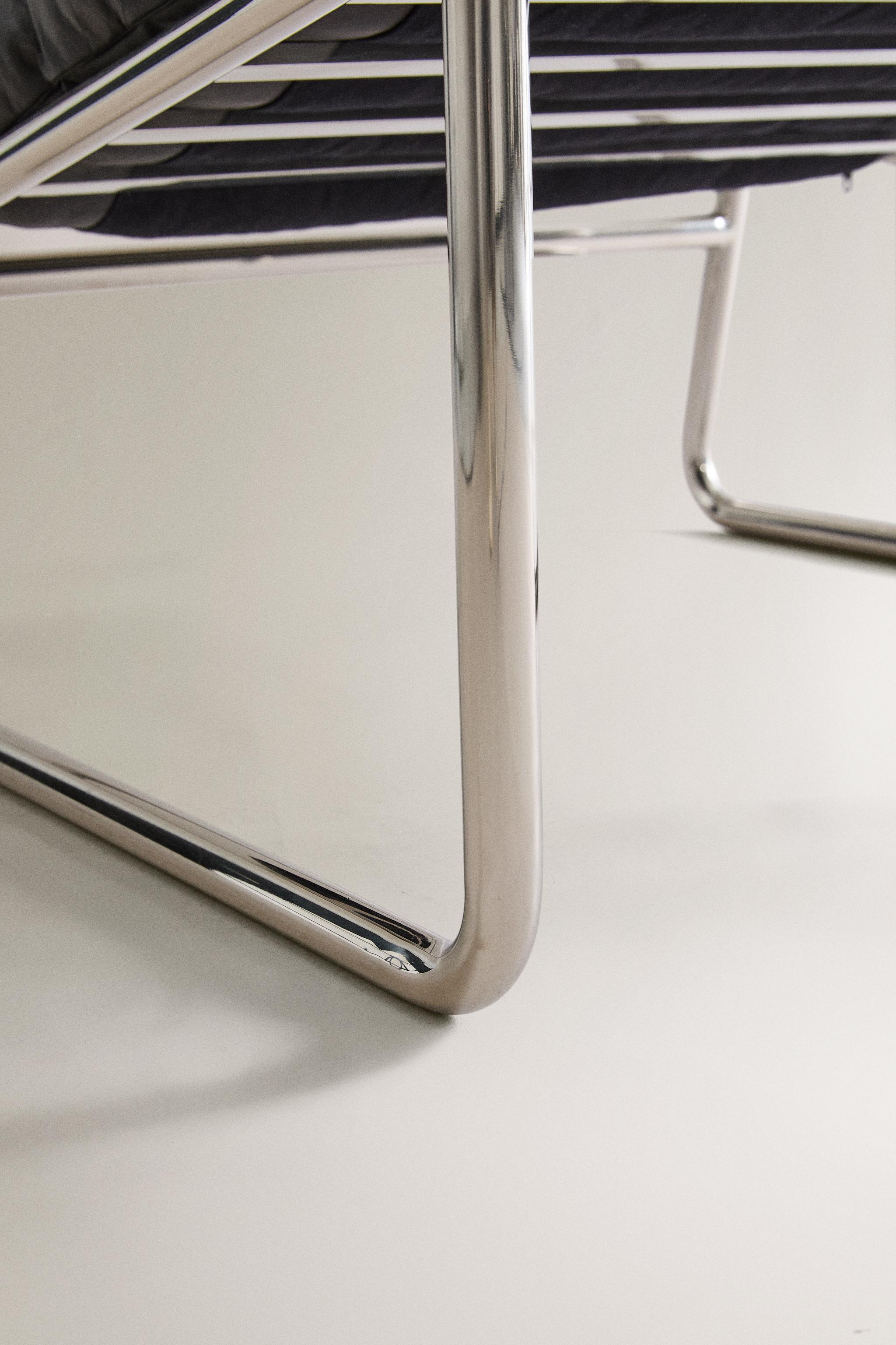 LEATHER AND STAINLESS STEEL ACCENT CHAIR